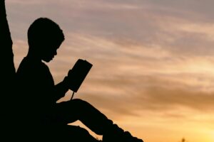 child silhouette book sunset 4k 1691849539