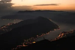 mountains coast aerial view city night lights 4k 1691839436