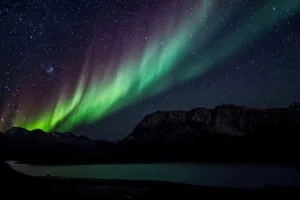 northern lights starry sky mountains lake night 4k 1691839436