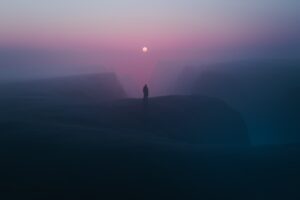 foggy horizons person standing at a top of mountains b4.jpg